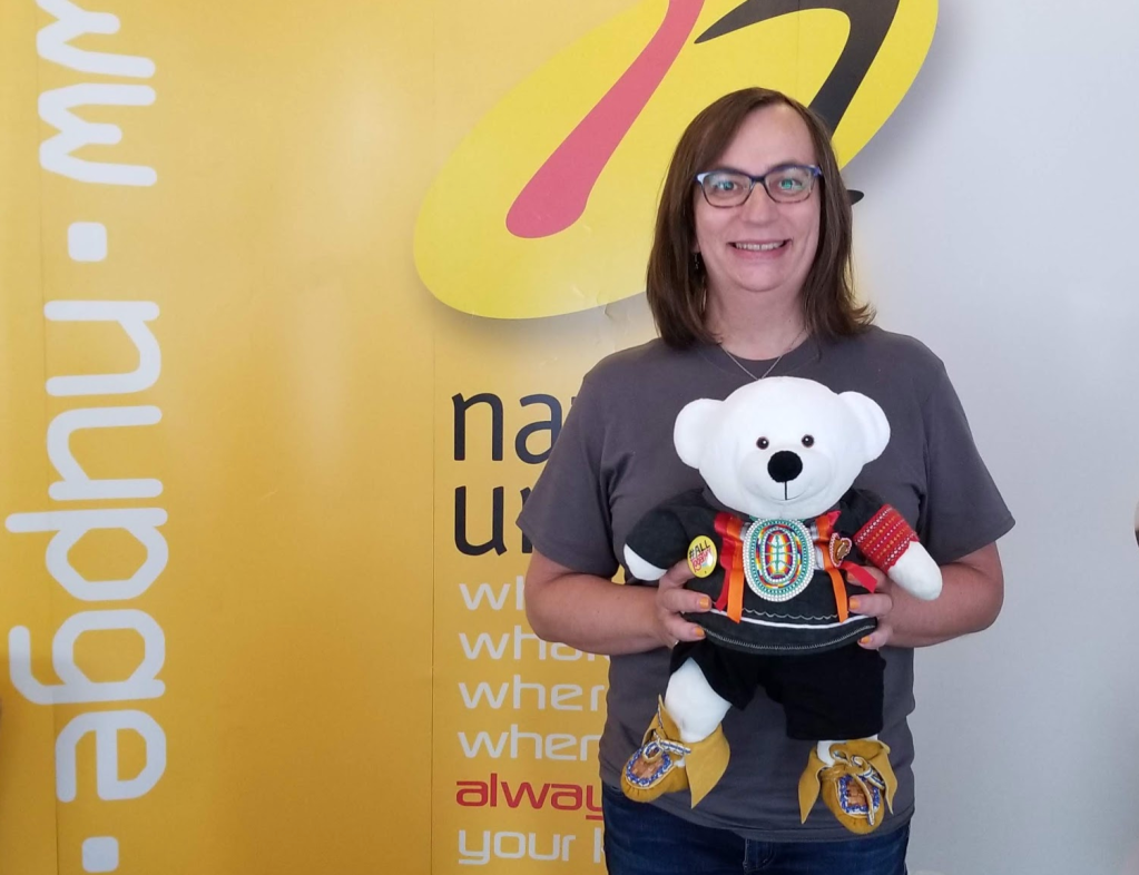 Morgane Oger poses at the NUPG leadership school holding Spirit Bear. At the NUPG leadership school with Spirit Bear. A member of the Carrier Sekani Tribal Council, Spirit Bear represents the 165,000 First Nations children impacted by the First Nations child welfare case at the Canadian Human Rights Tribunal.